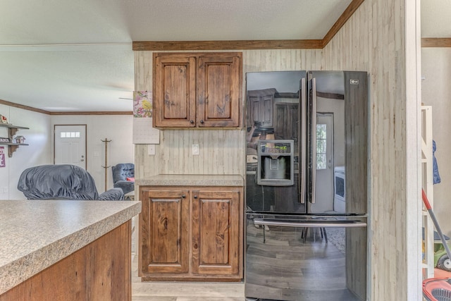 1005 Cohutta Beaverdale Rd, Cohutta, GA 30710 - kitchen featuring black fridge, light wood-style flooring, brown cabinets, ornamental molding, and light countertops