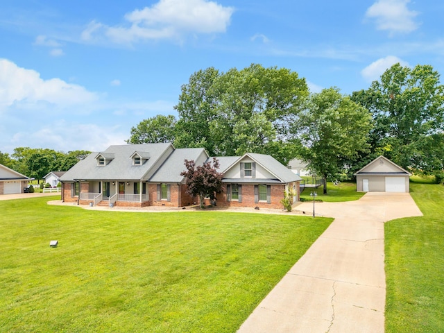 2195 Ooltewah Ringgold Rd, Ooltewah, TN 37363 - view of front of home with brick siding, a porch, an outbuilding, a detached garage, and a front yard