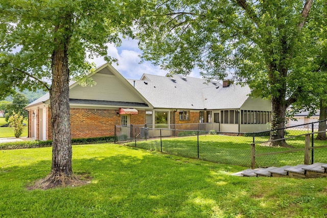 2195 Ooltewah Ringgold Rd, Ooltewah, TN 37363 - rear view of house with brick siding, a sunroom, and roof with shingles