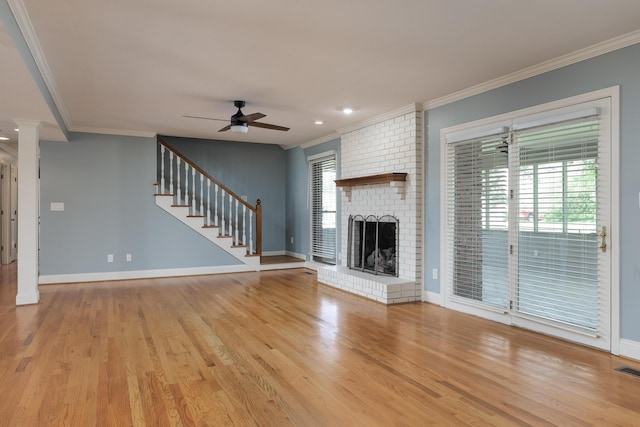2195 Ooltewah Ringgold Rd, Ooltewah, TN 37363 - unfurnished living room featuring a ceiling fan, crown molding, stairs, wood finished floors, and a fireplace