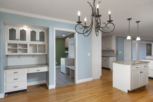 2195 Ooltewah Ringgold Rd, Ooltewah, TN 37363 - kitchen with crown molding, a kitchen island, light wood-style floors, white cabinets, and built in study area