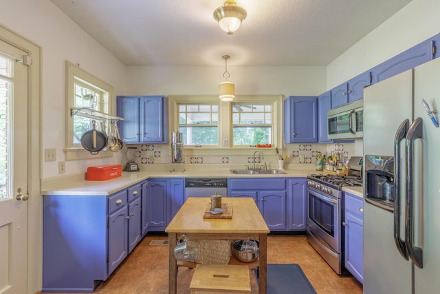3909 Sunset Ave, Chattanooga, TN 37411 - kitchen featuring stainless steel appliances, a sink, blue cabinetry, and light countertops