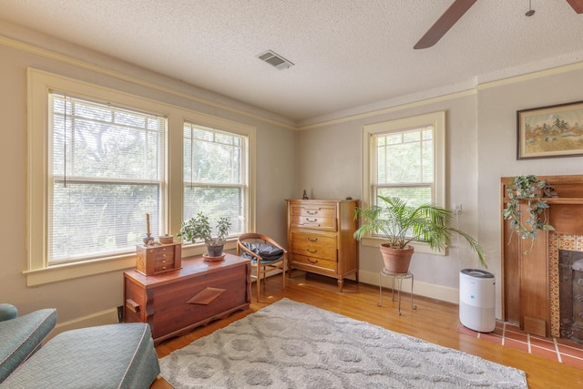 3909 Sunset Ave, Chattanooga, TN 37411 - living area featuring ceiling fan, wood finished floors, a textured ceiling, ornamental molding, and baseboards