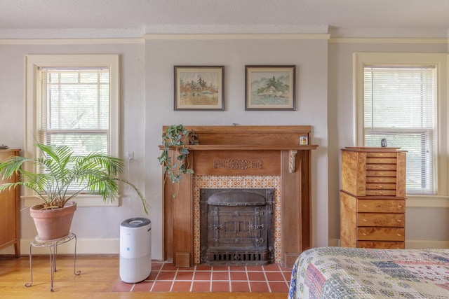 3909 Sunset Ave, Chattanooga, TN 37411 - bedroom with crown molding, a tiled fireplace, and baseboards