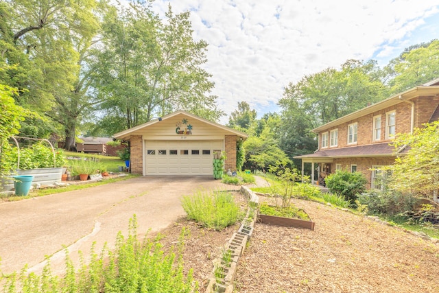 3909 Sunset Ave, Chattanooga, TN 37411 - view of front of property featuring brick siding, asphalt driveway, a garden, and a garage