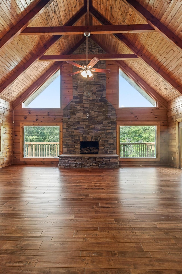 7524 Banther Rd, Harrison, TN 37341 - unfurnished living room featuring high vaulted ceiling, a stone fireplace, hardwood / wood-style floors, wooden walls, and a wood ceiling with exposed beams