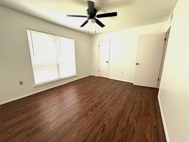 900 Mountain Creek Rd Unit V 478, Chattanooga, TN 37405 - unfurnished bedroom with dark wood-type flooring, baseboards, and a ceiling fan