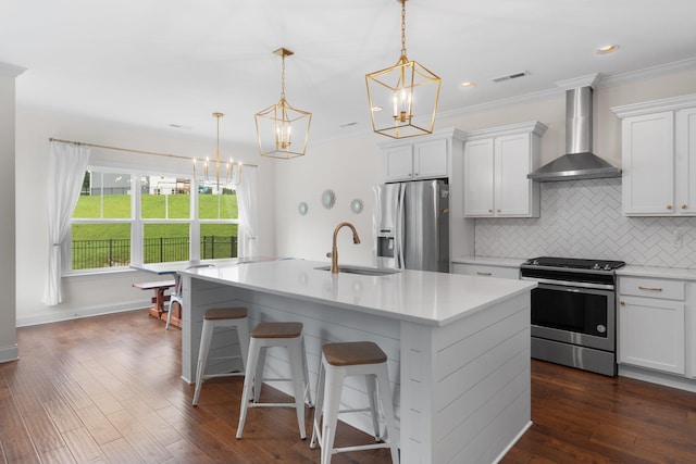 3620 Weathervane, Apison, TN 37302 - kitchen featuring stainless steel appliances, wall chimney range hood, a chandelier, decorative backsplash, and a center island with sink