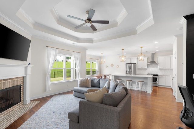 3620 Weathervane, Apison, TN 37302 - living area with crown molding, a ceiling fan, a brick fireplace, a chandelier, and hardwood / wood-style floors