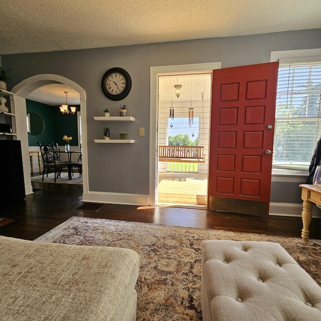 503 S Lovell Ave, Chattanooga, TN 37412 - foyer entrance featuring arched walkways, wood finished floors, a chandelier, and a textured ceiling