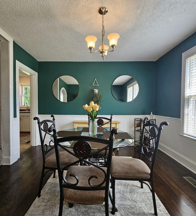 503 S Lovell Ave, Chattanooga, TN 37412 - dining space with wainscoting, a chandelier, a textured ceiling, and wood finished floors