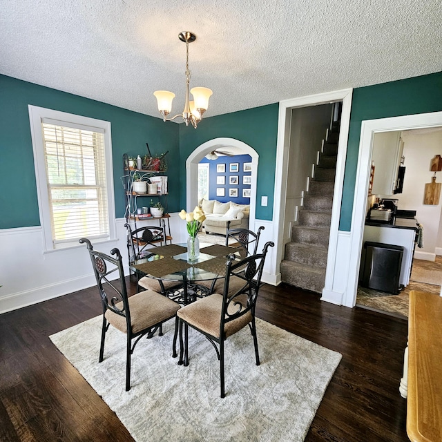 503 S Lovell Ave, Chattanooga, TN 37412 - dining space featuring arched walkways, stairway, dark wood-style flooring, a chandelier, and a textured ceiling