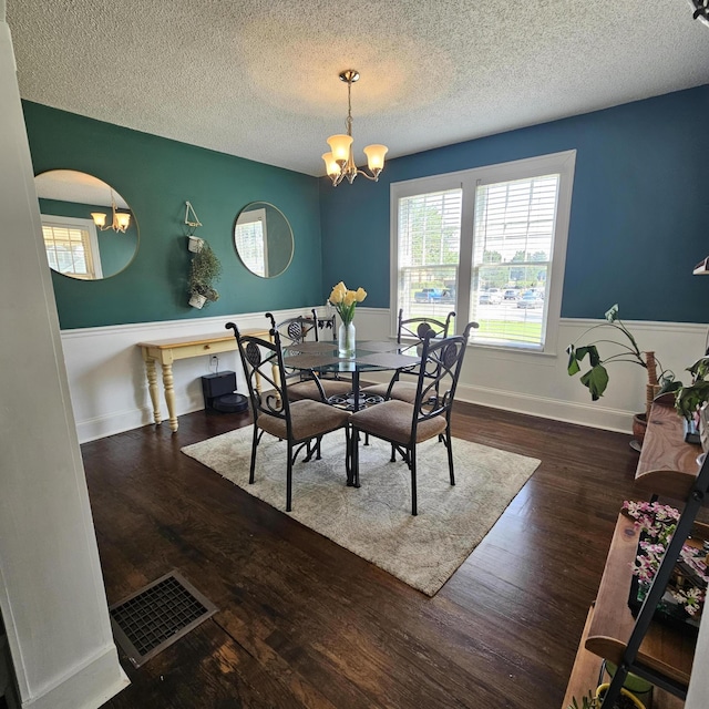 503 S Lovell Ave, Chattanooga, TN 37412 - dining space featuring a chandelier, a textured ceiling, wood finished floors, and a wainscoted wall