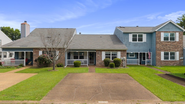 6755 Hickory Creek Rd, Chattanooga, TN 37421 - view of front of property with covered porch, brick siding, and a front lawn
