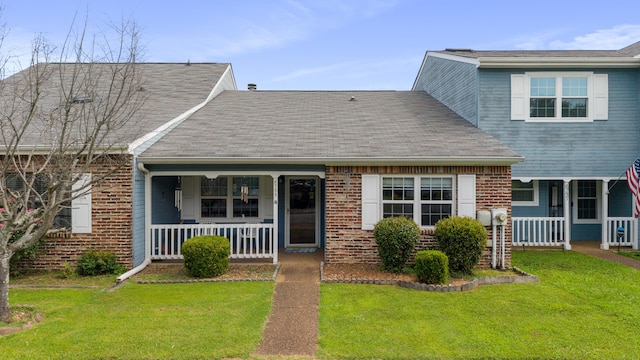 6755 Hickory Creek Rd, Chattanooga, TN 37421 - view of front of house with a porch, a front lawn, and brick siding