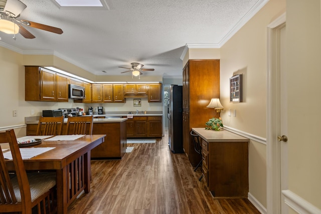 6755 Hickory Creek Rd, Chattanooga, TN 37421 - kitchen featuring stainless steel appliances, ceiling fan, dark wood-style flooring, light countertops, and brown cabinets