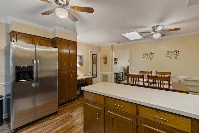 6755 Hickory Creek Rd, Chattanooga, TN 37421 - kitchen with stainless steel refrigerator with ice dispenser, a ceiling fan, wood finished floors, a skylight, and a textured ceiling