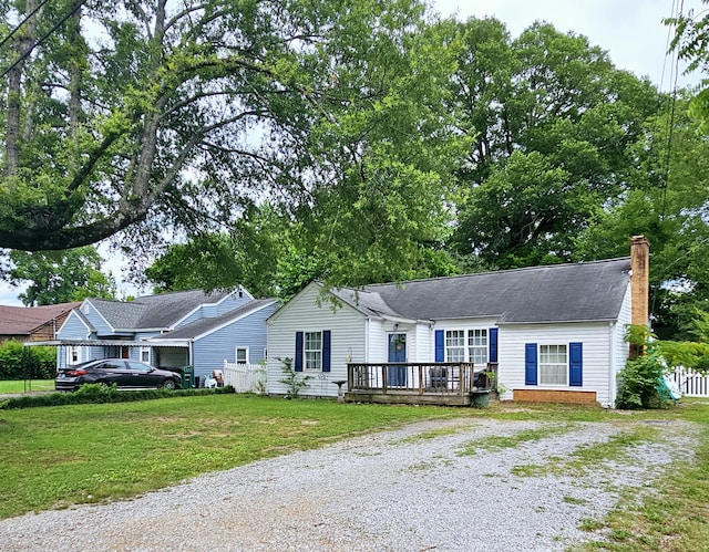 1610 Castleberry Ave, Chattanooga, TN 37412 - ranch-style home with driveway, a wooden deck, a chimney, and a front lawn