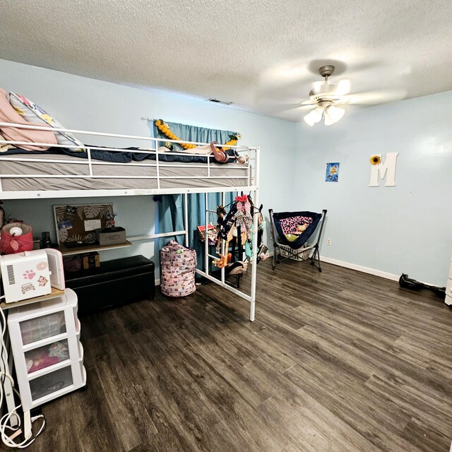 1610 Castleberry Ave, Chattanooga, TN 37412 - bedroom with wood finished floors, a textured ceiling, baseboards, and a ceiling fan