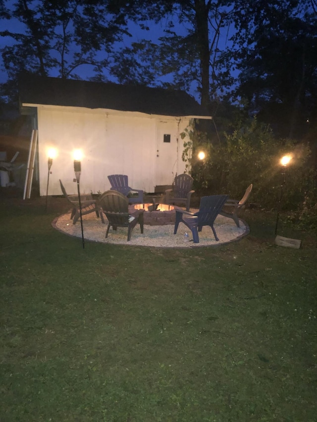 1610 Castleberry Ave, Chattanooga, TN 37412 - patio at twilight featuring a fire pit and a yard