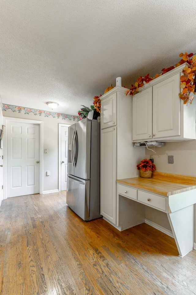 1820 Colonial Way Cir, Hixson, TN 37343 - kitchen with stainless steel refrigerator with ice dispenser, light wood-style flooring, light countertops, a textured ceiling, and white cabinets