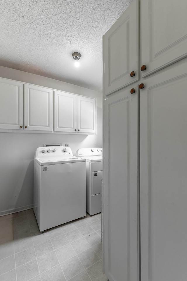 1820 Colonial Way Cir, Hixson, TN 37343 - laundry area with cabinet space, separate washer and dryer, a textured ceiling, and light tile patterned flooring
