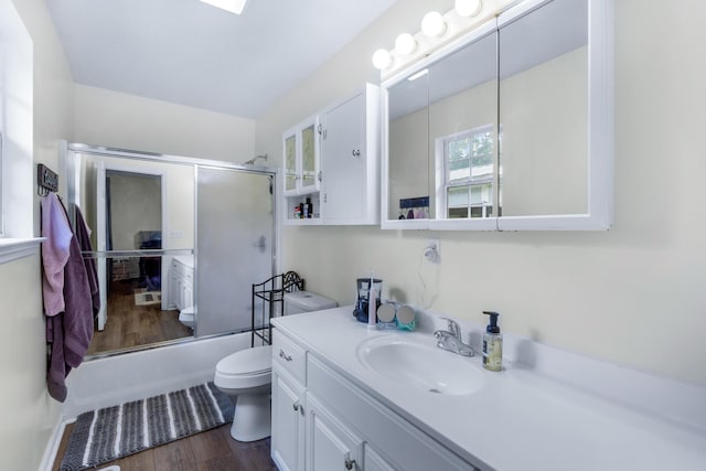 259 Osburn Rd, Chickamauga, GA 30707 - bathroom featuring wood finished floors, toilet, vanity, and combined bath / shower with glass door
