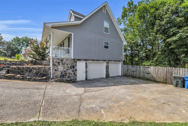 1128 Tiftonia View Rd, Chattanooga, TN 37419 - view of property exterior with a garage, concrete driveway, and stone siding