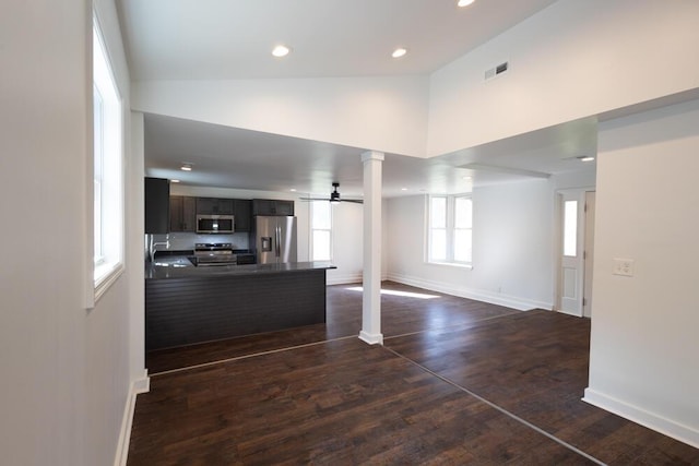 4407 Bennett Rd, Chattanooga, TN 37412 - kitchen featuring stainless steel appliances, ornate columns, dark countertops, open floor plan, and a peninsula
