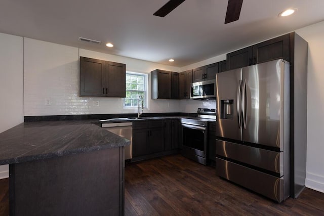4407 Bennett Rd, Chattanooga, TN 37412 - kitchen featuring stainless steel appliances, a peninsula, dark wood-style floors, ceiling fan, and recessed lighting