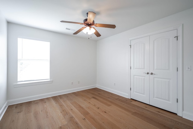 8539 Lexie Ln, Ooltewah, TN 37363 - unfurnished bedroom with wood finished floors, a closet, and a ceiling fan