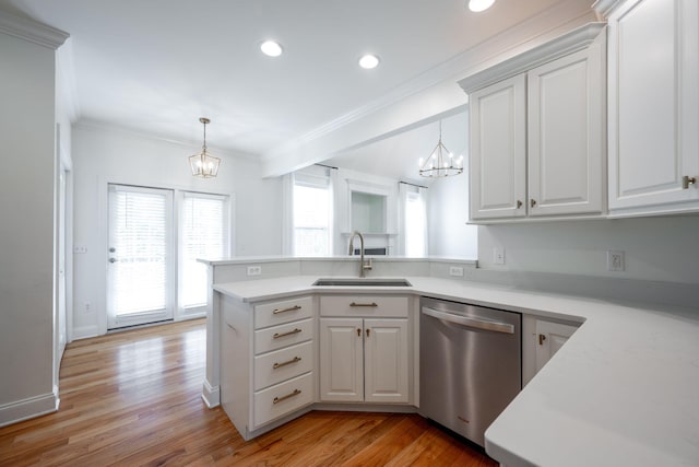 8539 Lexie Ln, Ooltewah, TN 37363 - kitchen featuring stainless steel dishwasher, a chandelier, a peninsula, light countertops, and ornamental molding