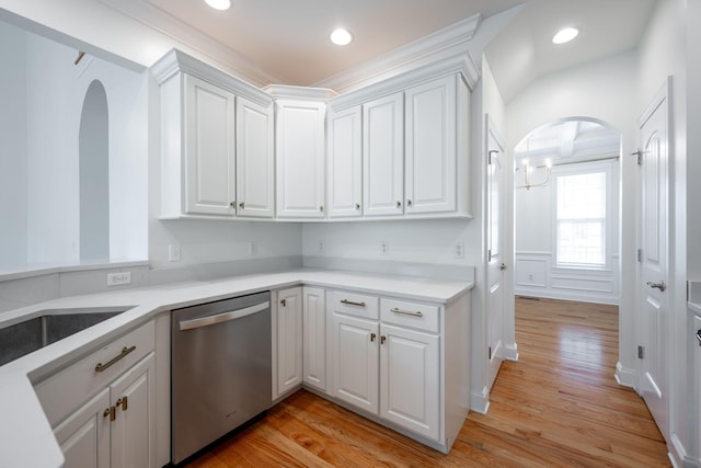 8539 Lexie Ln, Ooltewah, TN 37363 - kitchen featuring stainless steel dishwasher, arched walkways, white cabinetry, light wood-type flooring, and light countertops