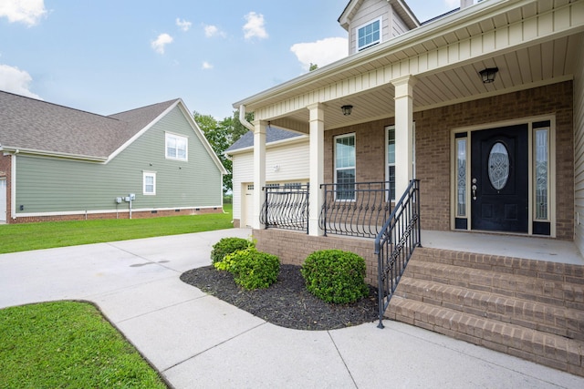 8539 Lexie Ln, Ooltewah, TN 37363 - view of exterior entry with a porch, concrete driveway, and brick siding