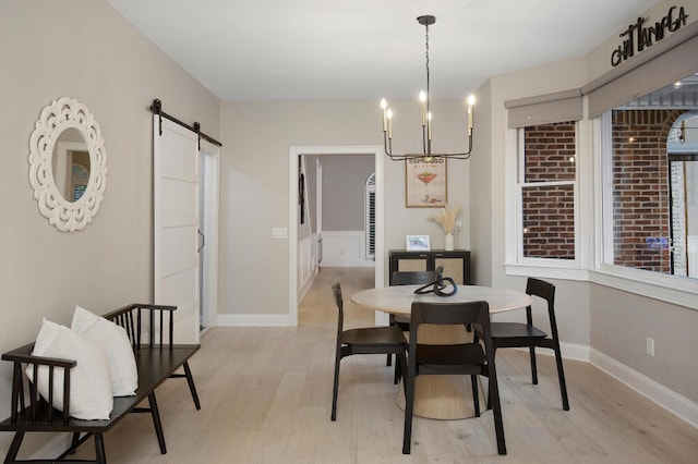 3 Chamblee Ct, Signal Mountain, TN 37377 - dining space featuring a barn door, light wood finished floors, and a chandelier