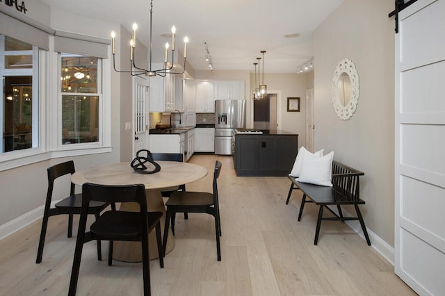 3 Chamblee Ct, Signal Mountain, TN 37377 - dining area with a chandelier, light wood-style flooring, rail lighting, and a barn door