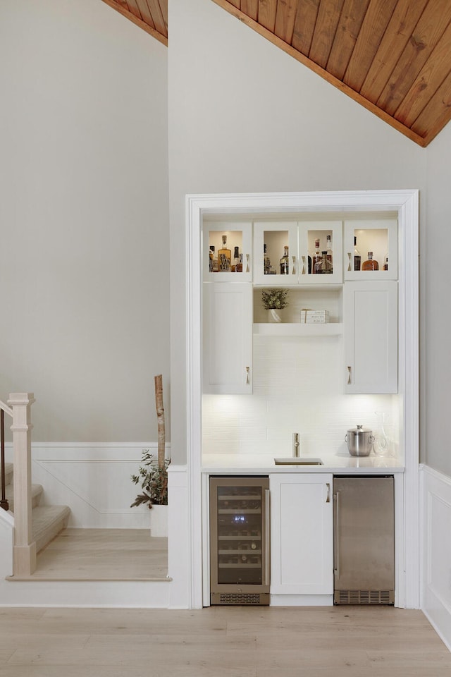 3 Chamblee Ct, Signal Mountain, TN 37377 - indoor wet bar featuring wine cooler, vaulted ceiling, wooden ceiling, a wainscoted wall, and stairway