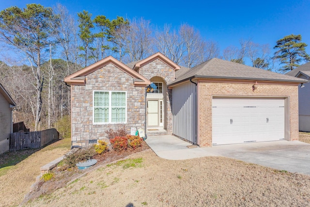 2367 Lake Mist Dr, Chattanooga, TN 37421 - view of front facade featuring stone siding, an attached garage, and driveway