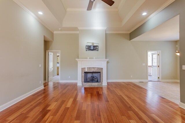 2367 Lake Mist Dr, Chattanooga, TN 37421 - unfurnished living room with a raised ceiling, a ceiling fan, light wood finished floors, a fireplace, and ornamental molding