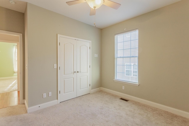 2367 Lake Mist Dr, Chattanooga, TN 37421 - unfurnished bedroom featuring carpet flooring, multiple windows, a closet, and a ceiling fan
