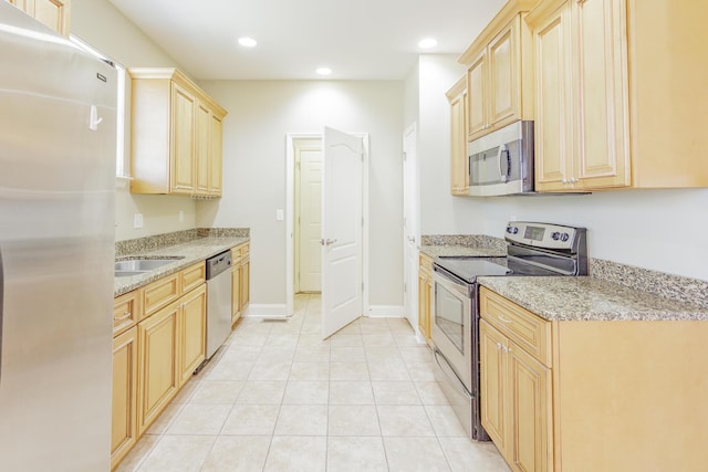 2367 Lake Mist Dr, Chattanooga, TN 37421 - kitchen with appliances with stainless steel finishes, light brown cabinets, light tile patterned flooring, light stone countertops, and recessed lighting