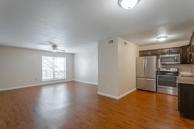 900 Mountain Creek Rd Unit Q263, Chattanooga, TN 37405 - kitchen with appliances with stainless steel finishes, dark brown cabinetry, wood finished floors, a ceiling fan, and open floor plan