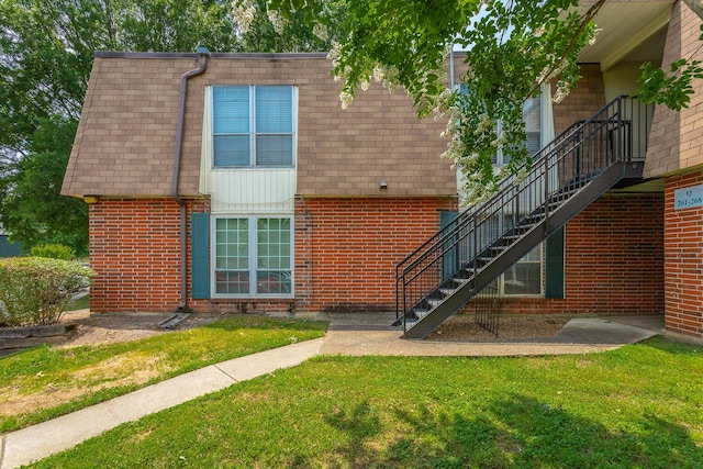 900 Mountain Creek Rd Unit Q263, Chattanooga, TN 37405 - doorway to property featuring brick siding, a yard, mansard roof, and roof with shingles