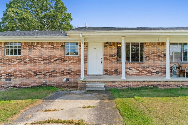 1307 Park Forrest Dr, Fort Oglethorpe, GA 30742 - property entrance with brick siding, a lawn, and roof with shingles