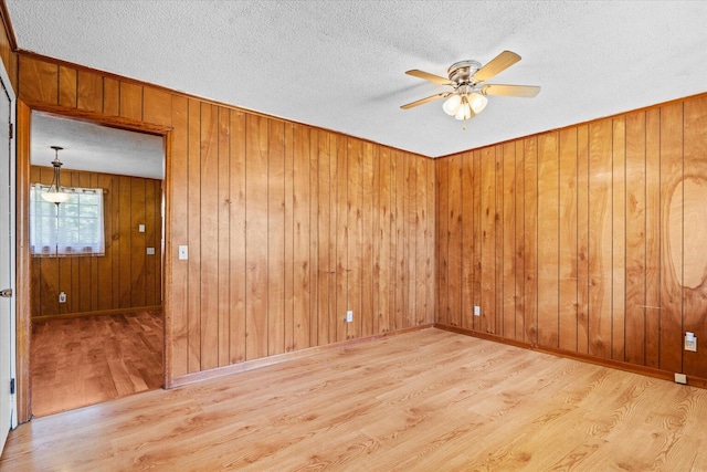 1307 Park Forrest Dr, Fort Oglethorpe, GA 30742 - unfurnished room featuring wood finished floors, ceiling fan, a textured ceiling, and wooden walls