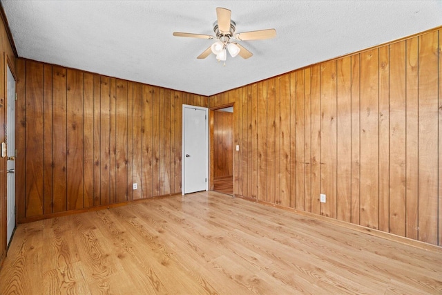 1307 Park Forrest Dr, Fort Oglethorpe, GA 30742 - empty room with ceiling fan, wood finished floors, a textured ceiling, and wooden walls