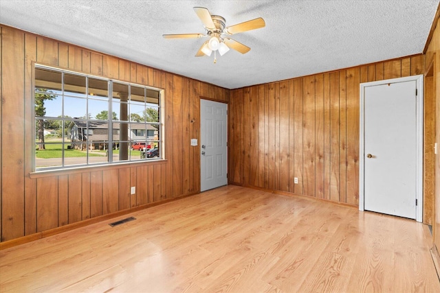 1307 Park Forrest Dr, Fort Oglethorpe, GA 30742 - unfurnished room with wood finished floors, a textured ceiling, ceiling fan, and wooden walls