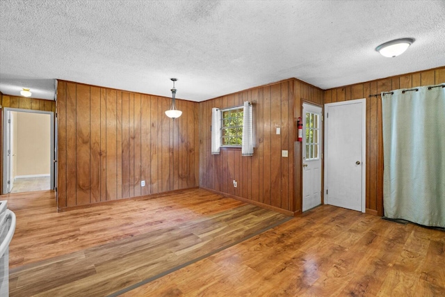 1307 Park Forrest Dr, Fort Oglethorpe, GA 30742 - entrance foyer with a textured ceiling, wood finished floors, and wood walls