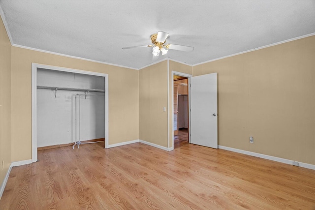 1307 Park Forrest Dr, Fort Oglethorpe, GA 30742 - unfurnished bedroom with crown molding, light wood-style floors, a closet, a ceiling fan, and a textured ceiling