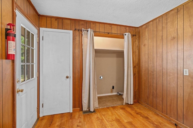 1307 Park Forrest Dr, Fort Oglethorpe, GA 30742 - unfurnished room featuring light wood-style flooring, wooden walls, and a textured ceiling